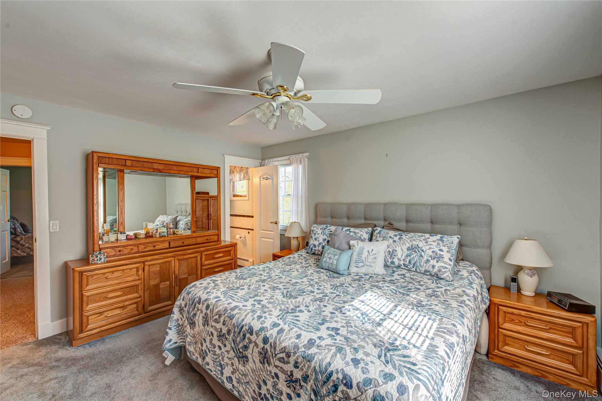 3 Walnut Road Rocky Point, NY 11778 - Photo 25 of 46 a bedroom with a bed and a chandelier