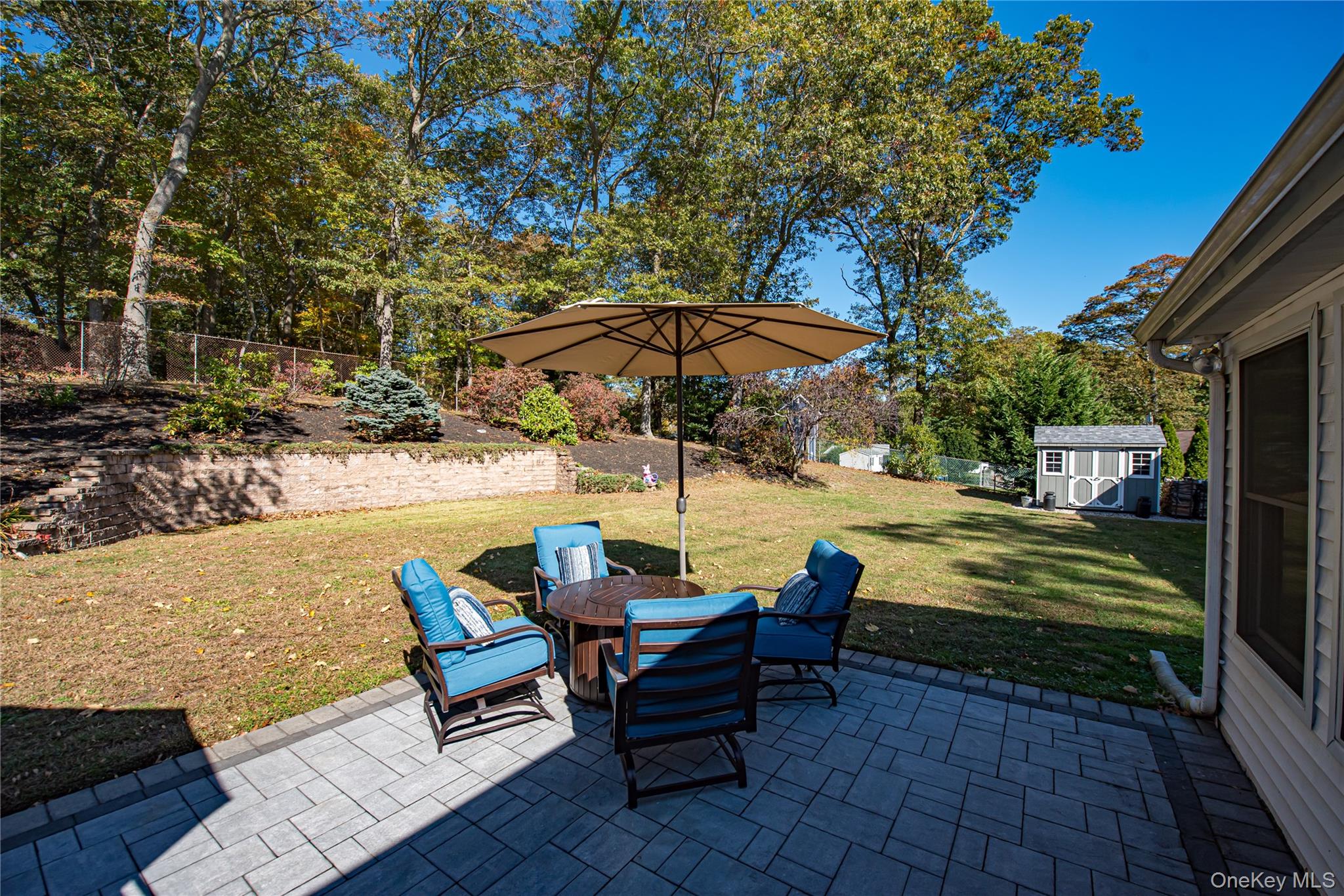 3 Walnut Road Rocky Point, NY 11778 - Photo 33 of 46 a view of a patio with table and chairs under an umbrella