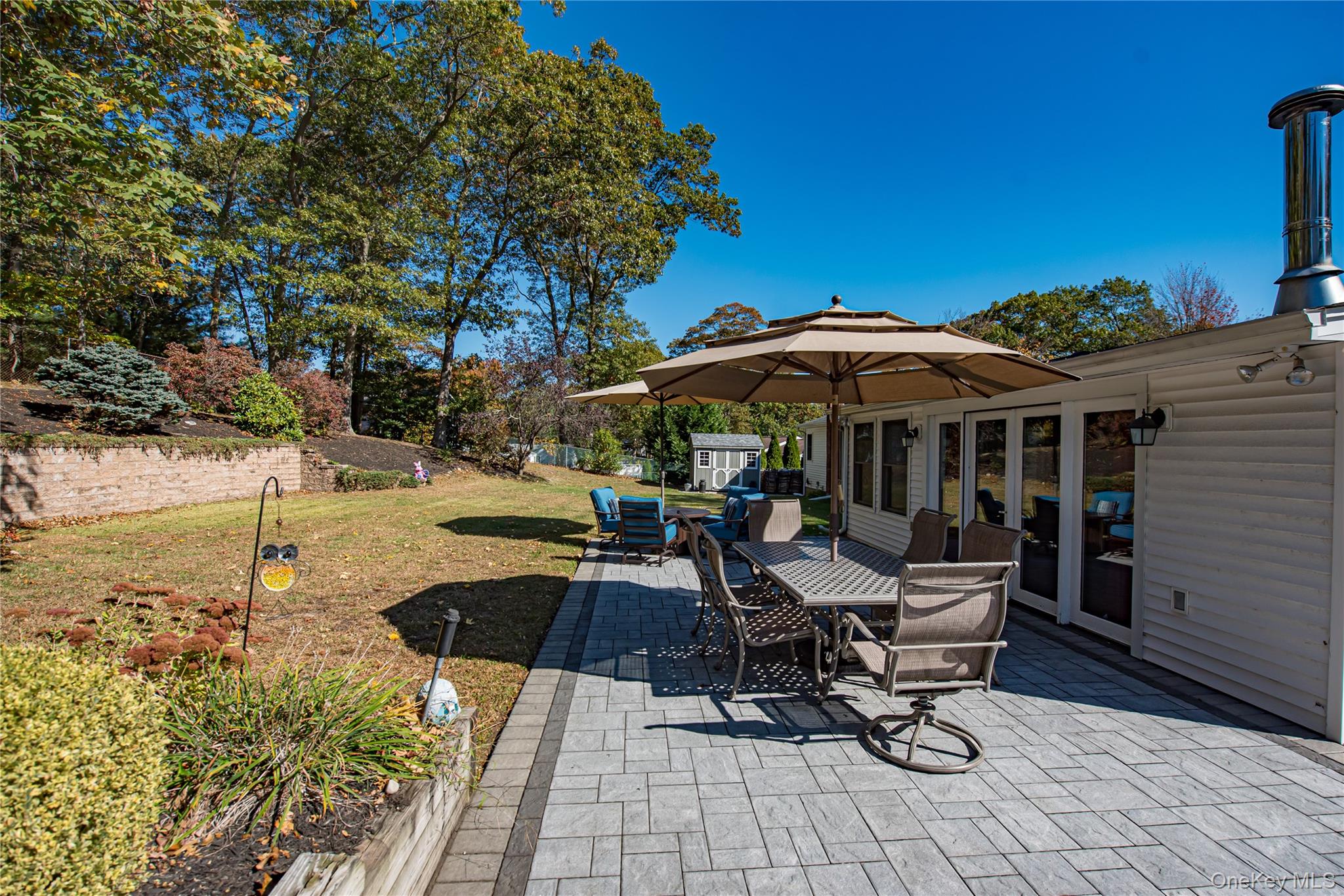 3 Walnut Road Rocky Point, NY 11778 - Photo 34 of 46 a view of backyard with outdoor seating and trees