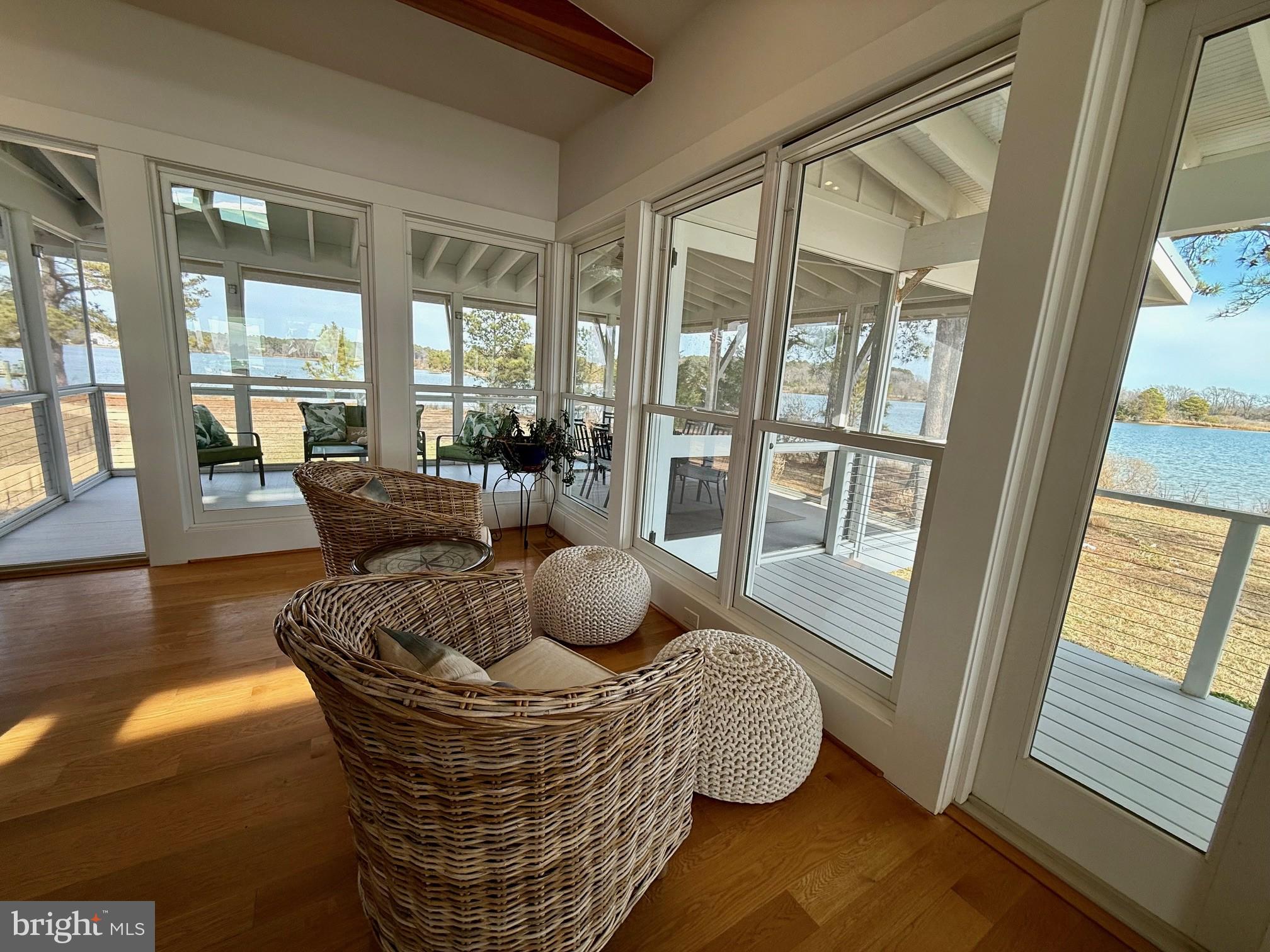 49005 Harry James Road Ridge, MD 20680 - Photo 20 of 71 a living room with furniture and floor to ceiling windows
