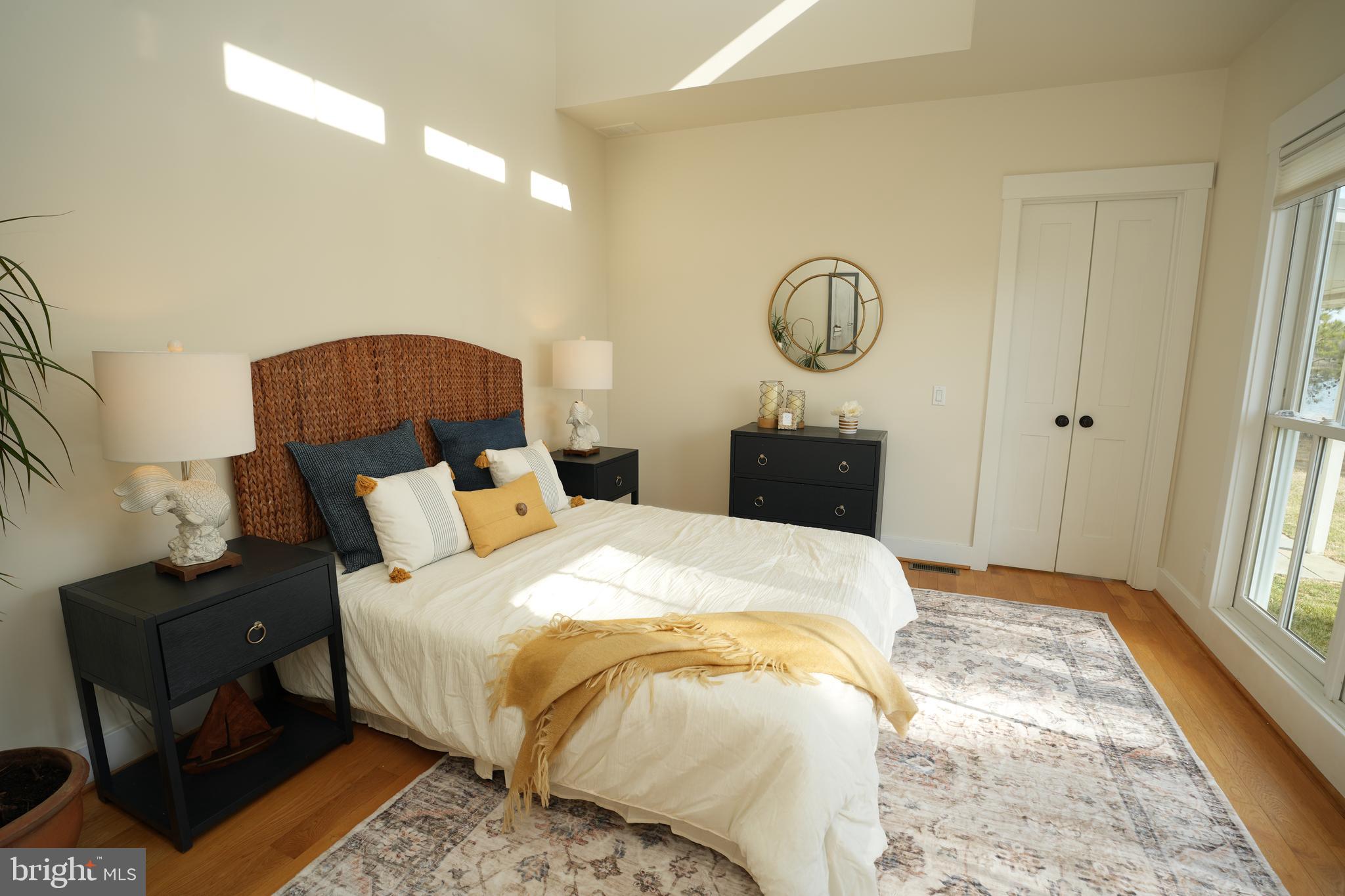 49005 Harry James Road Ridge, MD 20680 - Photo 28 of 71 a bedroom with bed and wooden floor