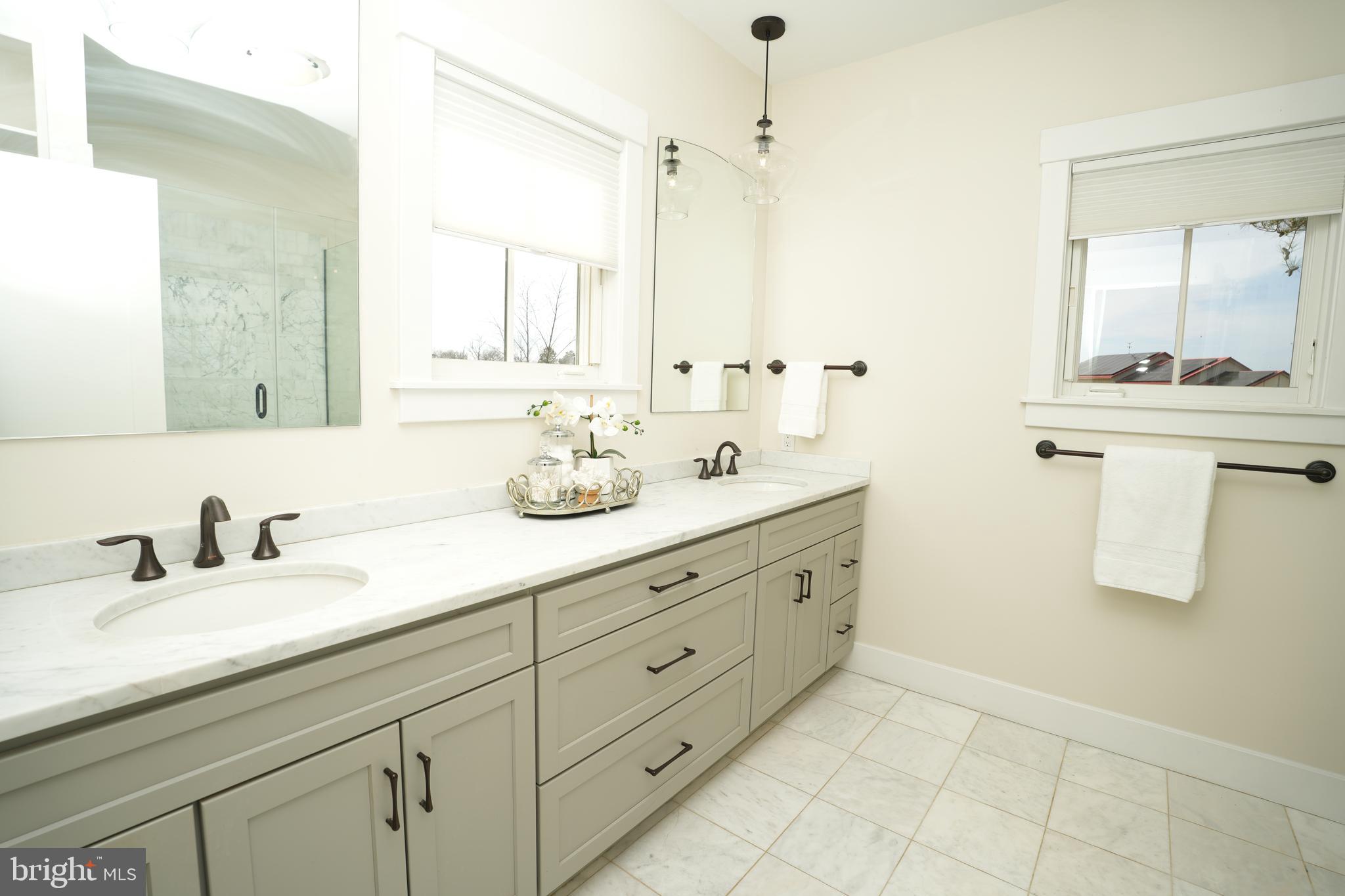 49005 Harry James Road Ridge, MD 20680 - Photo 31 of 71 a bathroom with double sink and a mirror