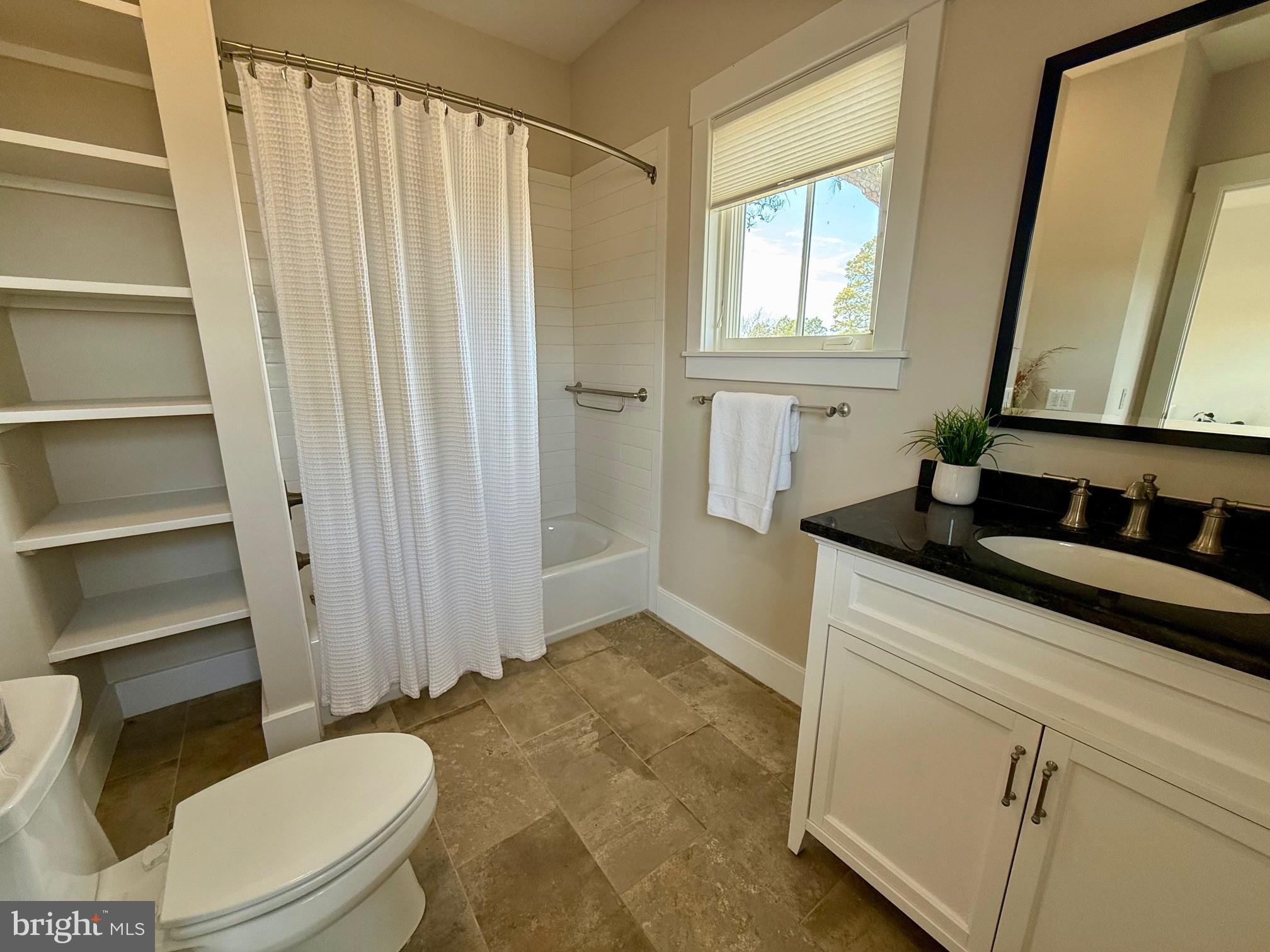 49005 Harry James Road Ridge, MD 20680 - Photo 37 of 71 a bathroom with a sink a toilet a window and shower