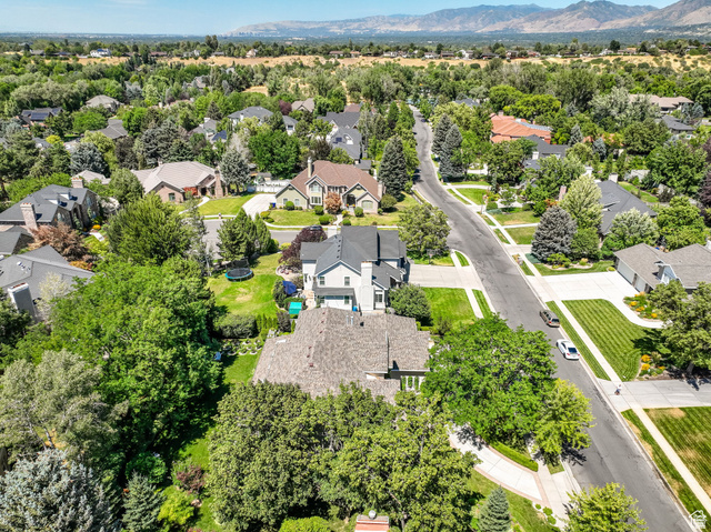 7740 Keswick Road Sandy, UT 84093 - Photo 69 of 74 Aerial perspective showcasing a residential street with diverse home exteriors, mature trees, and manicured lawns