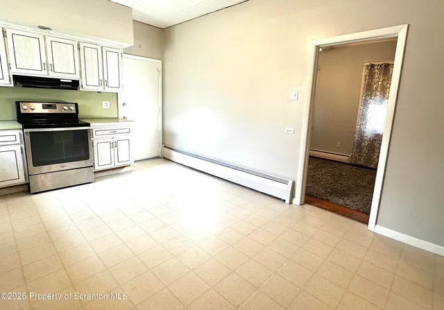 a view of a kitchen with an empty space and a window