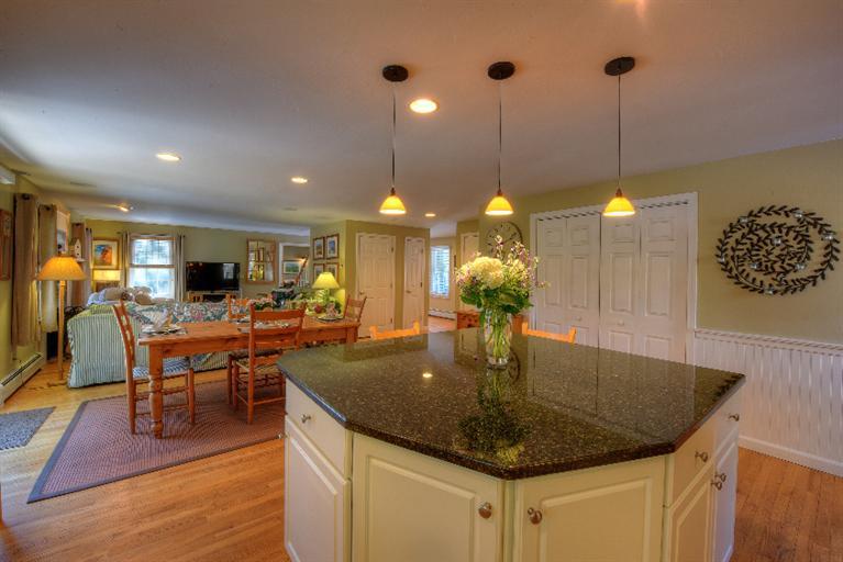 1325 Old Post Road Marstons Mills, MA 02648 - Photo 11 of 35 a view of a dining room and livingroom with furniture wooden floor a chandelier