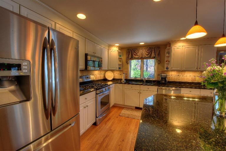 1325 Old Post Road Marstons Mills, MA 02648 - Photo 13 of 35 a kitchen with stainless steel appliances granite countertop a refrigerator a stove and a sink