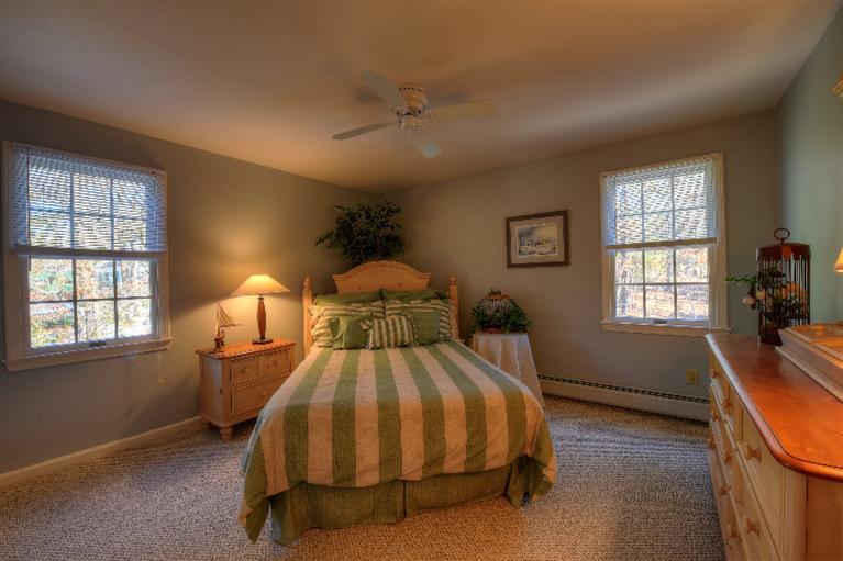 1325 Old Post Road Marstons Mills, MA 02648 - Photo 23 of 35 a bed sitting in a bedroom next to a window