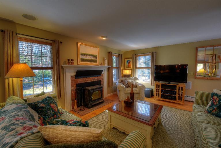 1325 Old Post Road Marstons Mills, MA 02648 - Photo 6 of 35 a living room with furniture a flat screen tv and a fireplace