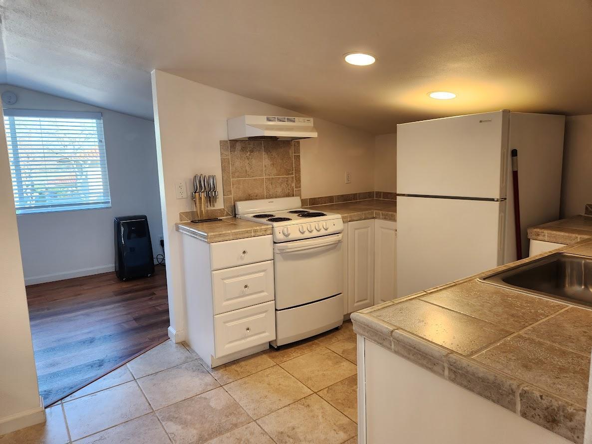 5521 Churn Crk Road Redding, CA 96002 - Photo 118 of 154 a kitchen with a stove cabinets and wooden floor