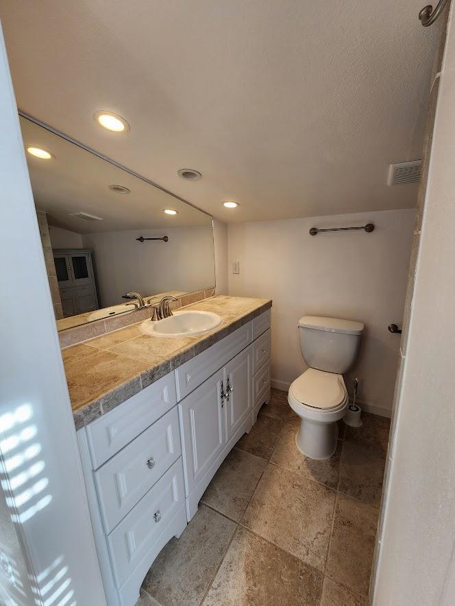 5521 Churn Crk Road Redding, CA 96002 - Photo 120 of 154 a spacious bathroom with a granite countertop sink a toilet and a mirror