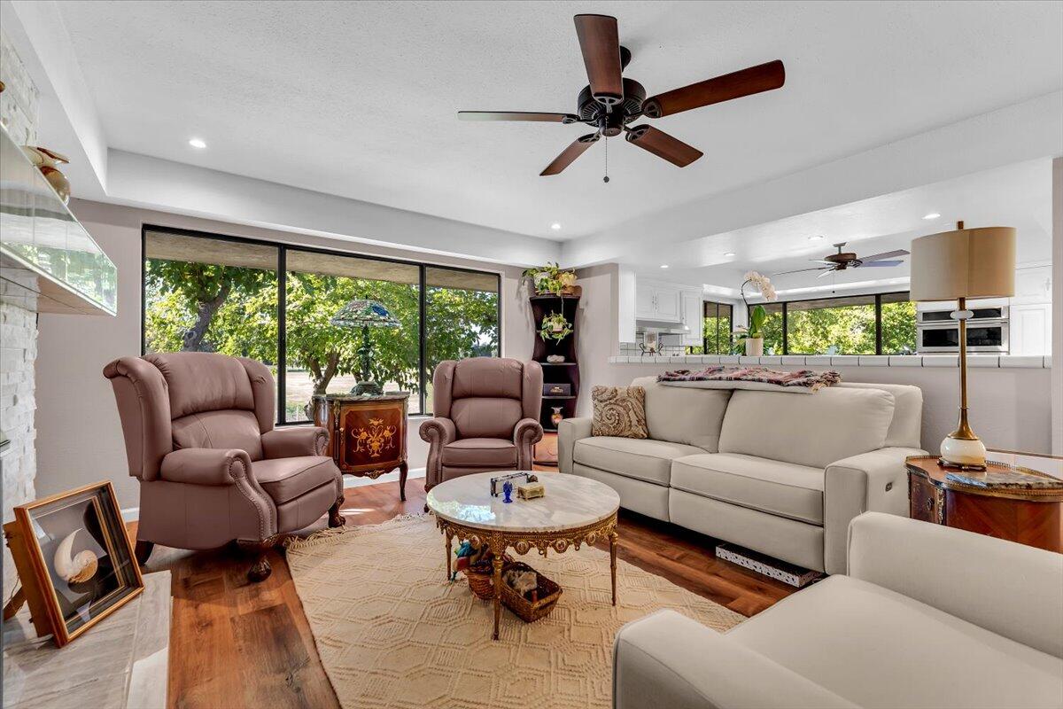 5521 Churn Crk Road Redding, CA 96002 - Photo 21 of 154 a living room with furniture a ceiling fan and a large window