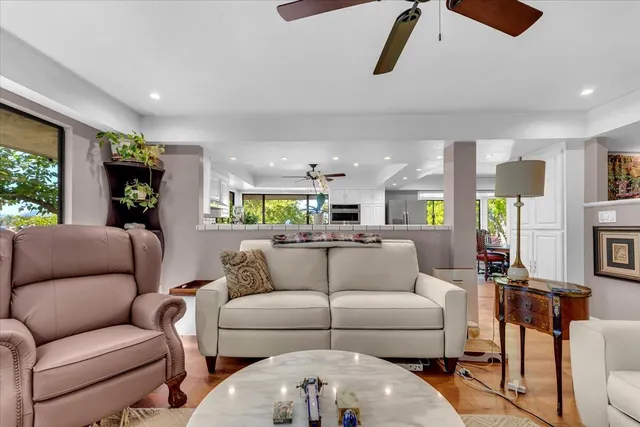 a living room with furniture and a floor to ceiling window