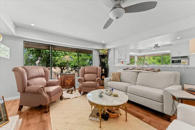 a view of a house with backyard and a sitting area