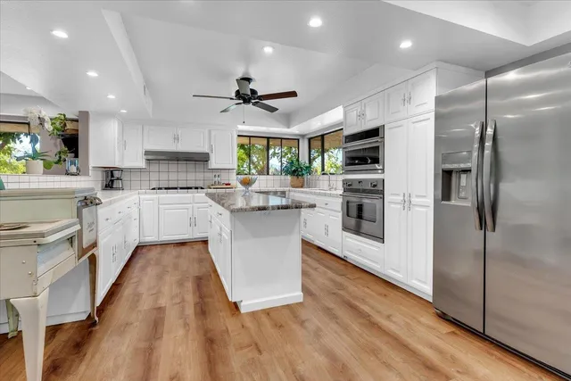a view of a patio with table and chairs potted plants with large tree