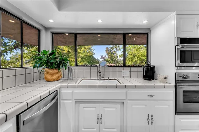 a view of a house with backyard garden and sitting area