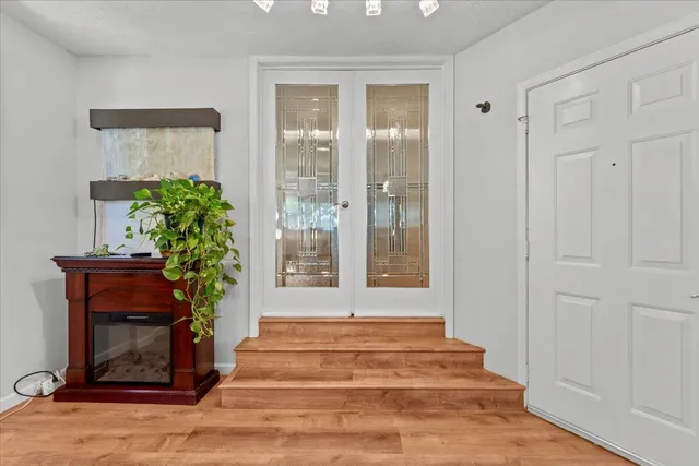 a view of a house with backyard and a tree