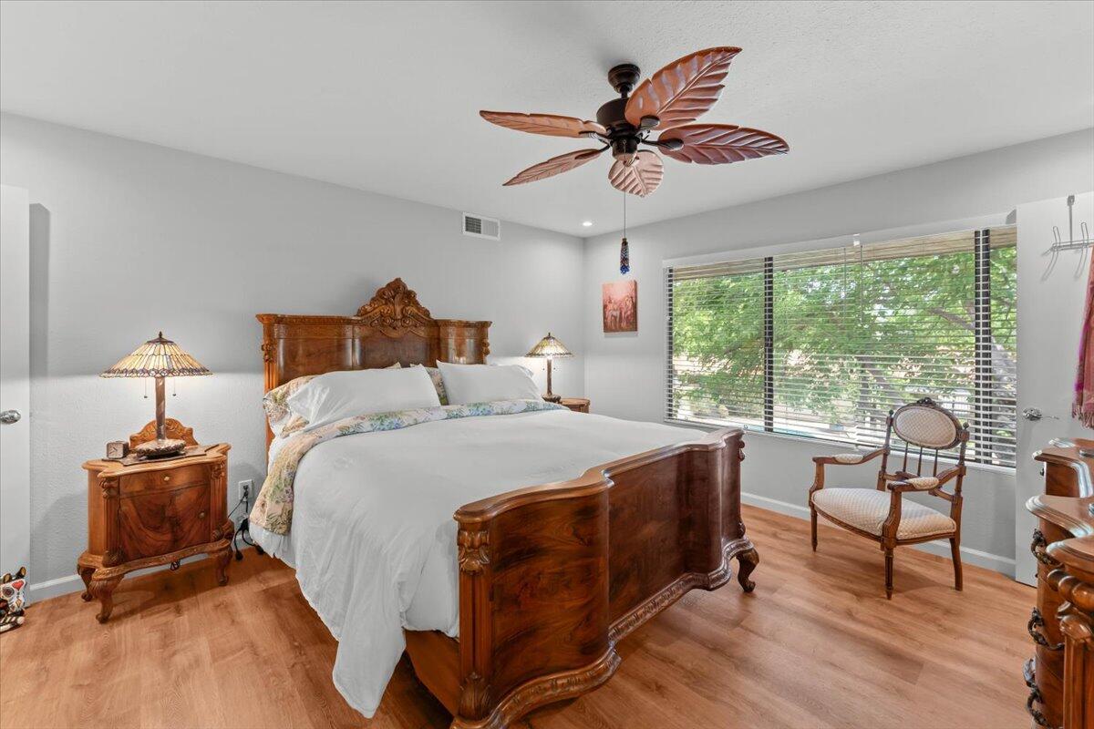 5521 Churn Crk Road Redding, CA 96002 - Photo 49 of 154 a bed room with a bed and a chandelier