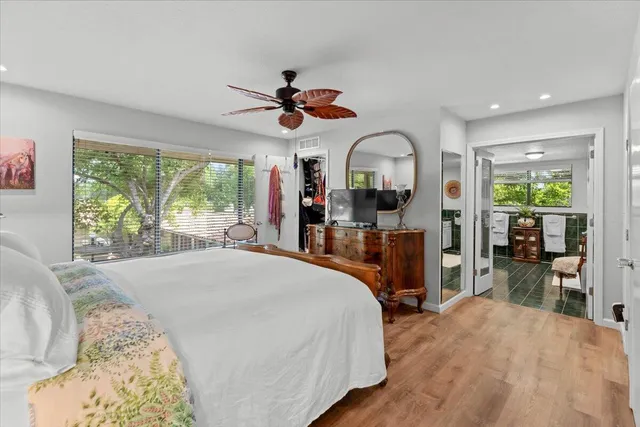 an aerial view of a city with lots of residential buildings ocean and mountain view in back