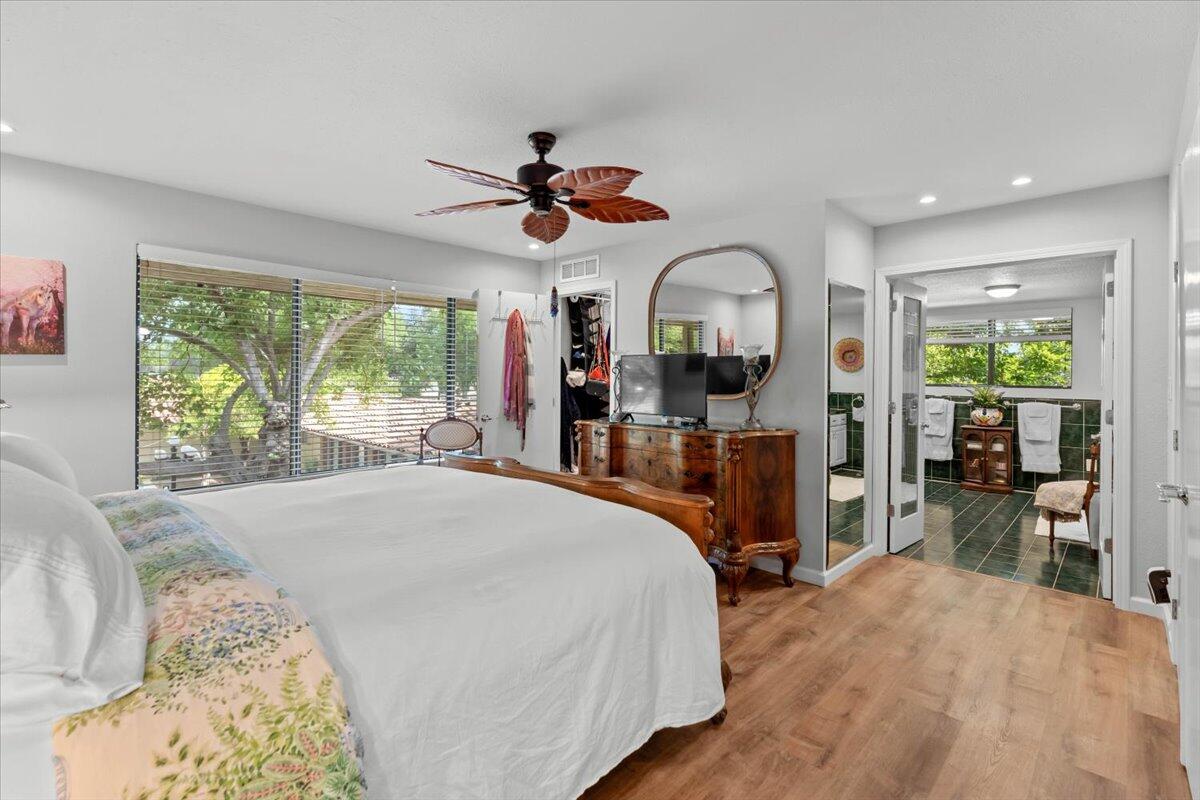 5521 Churn Crk Road Redding, CA 96002 - Photo 50 of 154 a bedroom with a bed and a large window with the outer view