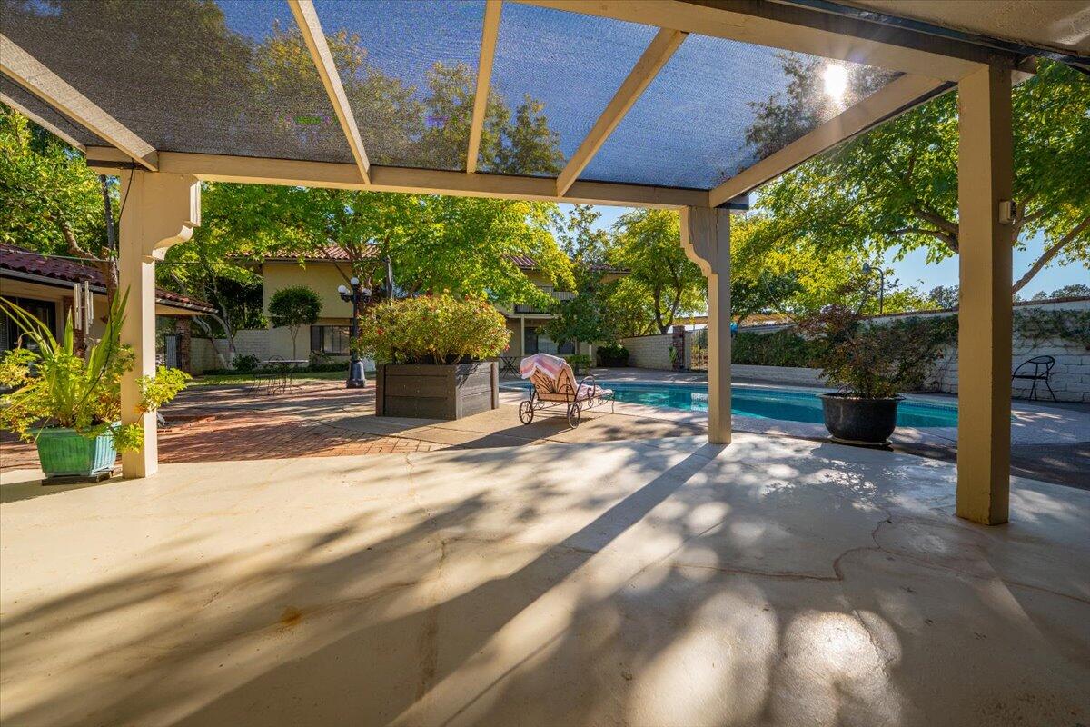 5521 Churn Crk Road Redding, CA 96002 - Photo 74 of 154 a view of a patio with table and chairs potted plants with large tree