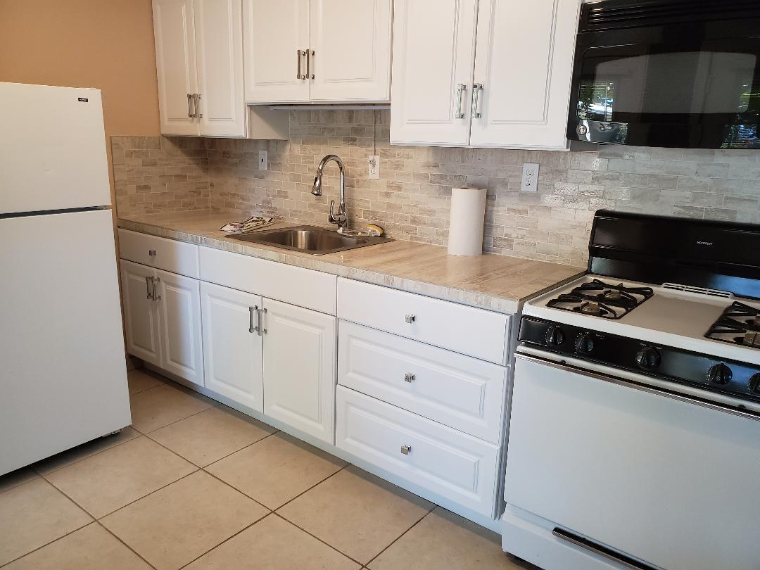5521 Churn Crk Road Redding, CA 96002 - Photo 80 of 154 a kitchen with white cabinets and appliances