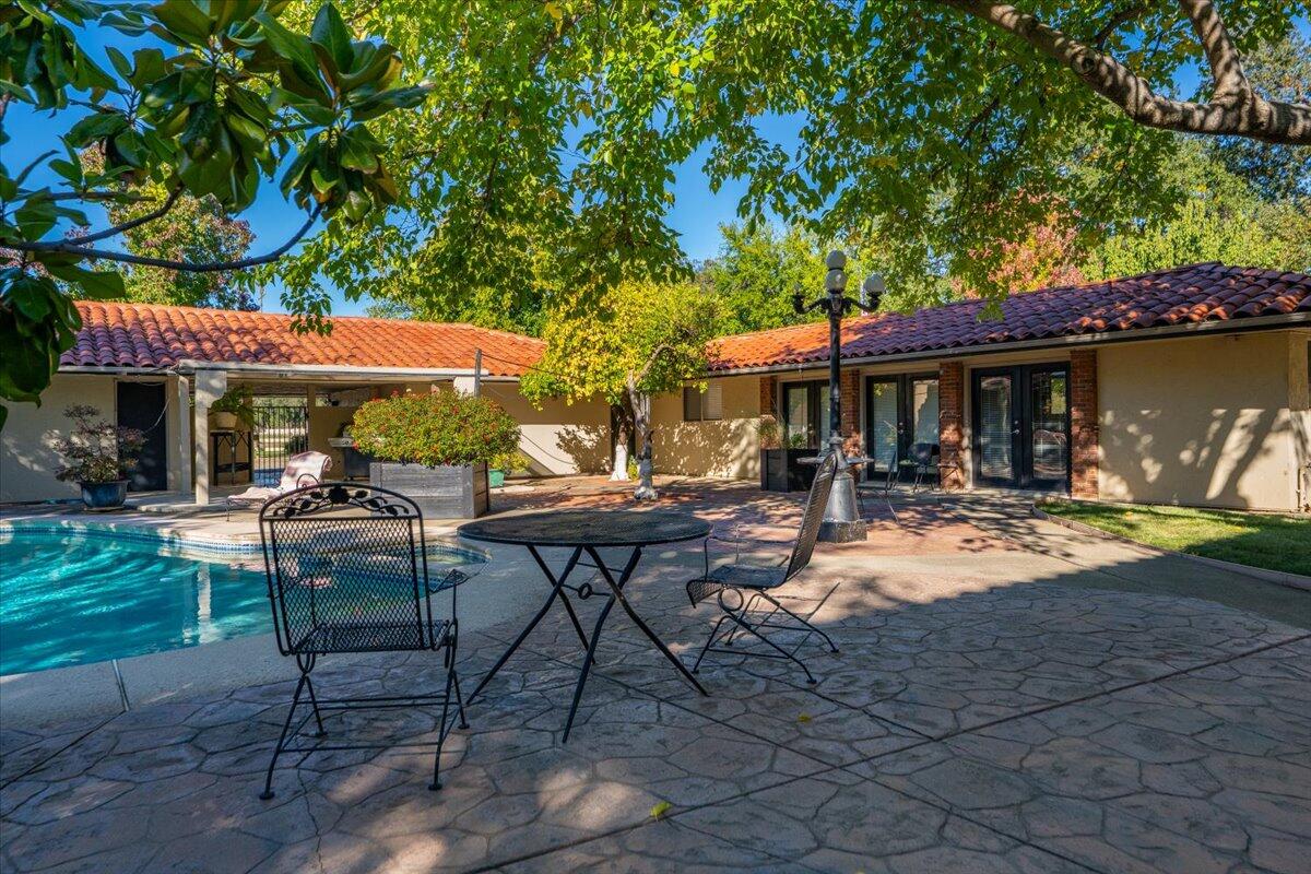 5521 Churn Crk Road Redding, CA 96002 - Photo 93 of 154 a view of a table and chairs in patio in front of a house