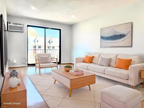 a living room with furniture and a large window