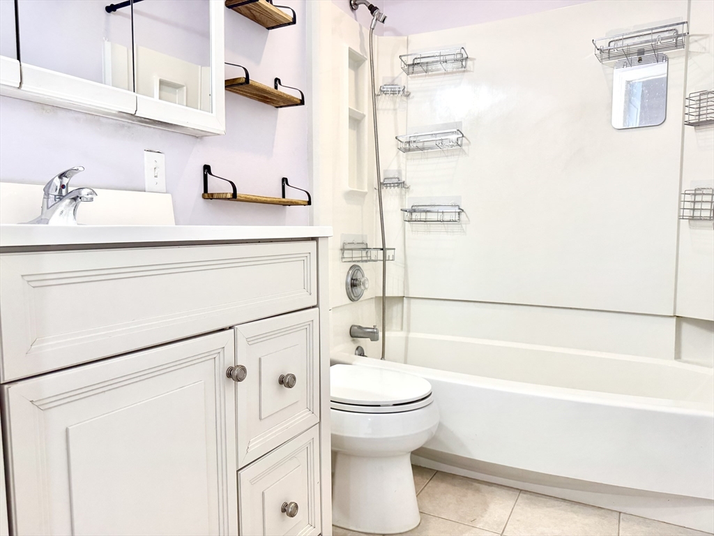 36 Main Street, Unit 26 North Reading, MA 01864 - Photo 11 of 19 a bathroom with a sink a toilet and a bathtub