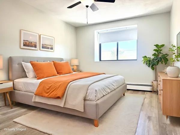 a bedroom with a bed and a potted plant