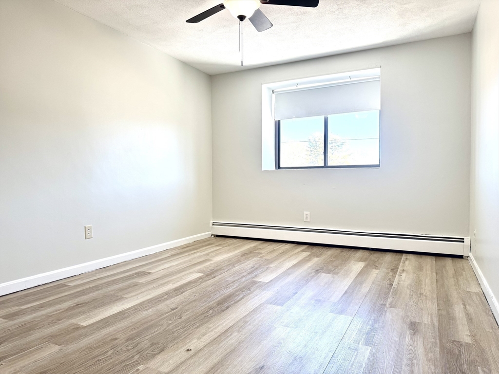 36 Main Street, Unit 26 North Reading, MA 01864 - Photo 13 of 19 a view of an empty room with wooden floor and a window
