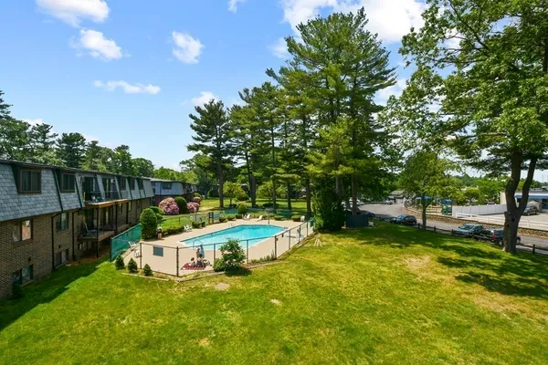 a view of a house with swimming pool and sitting area