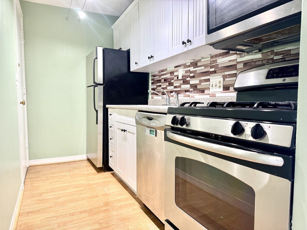 36 Main Street, Unit 26 North Reading, MA 01864 - Photo 2 of 19 a view of kitchen with refrigerator and cabinets