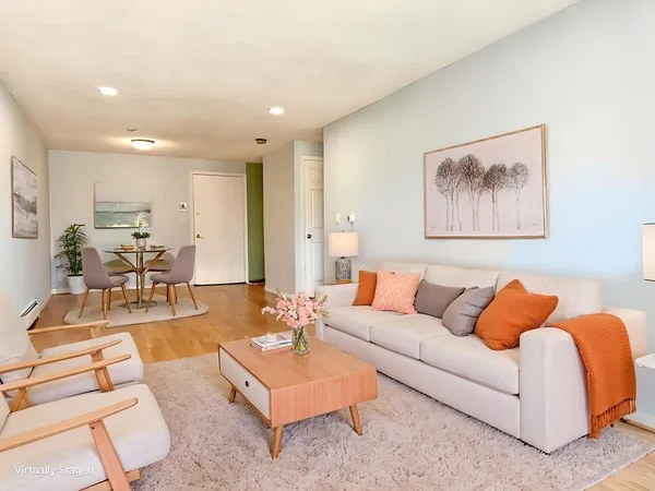 a living room with furniture and kitchen view