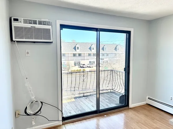 a view of entryway with wooden floor and door