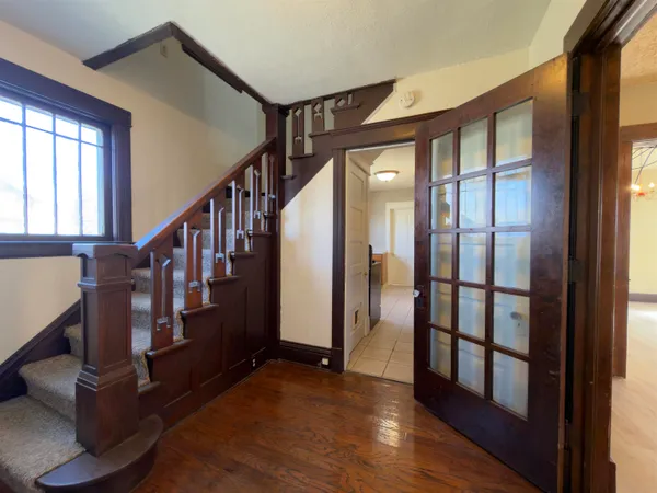 a view of an entryway with wooden floor and door