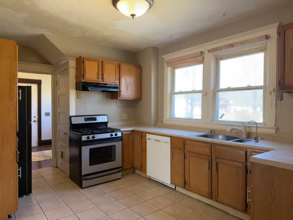 a kitchen with stainless steel appliances a stove sink and cabinets