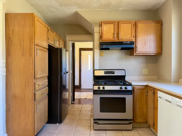 a kitchen with stainless steel appliances a stove a microwave and cabinets