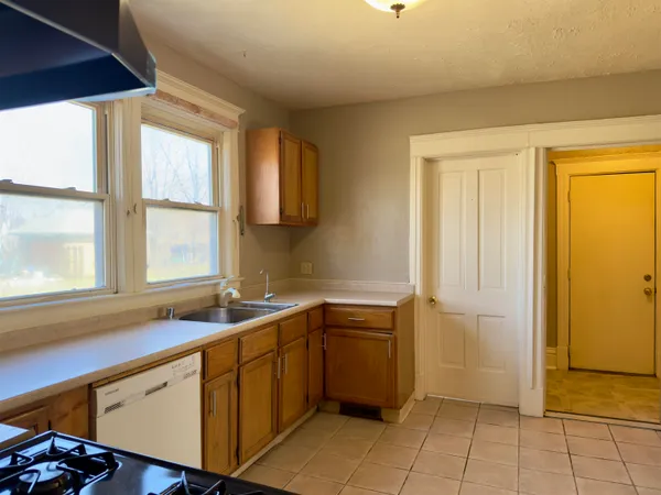 a kitchen with a sink cabinets and window