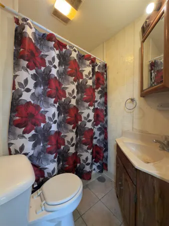 a bathroom with a sink mirror vanity and toilet
