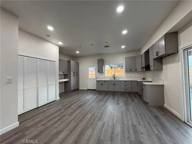 a kitchen with stainless steel appliances kitchen island wooden cabinets and granite counter tops