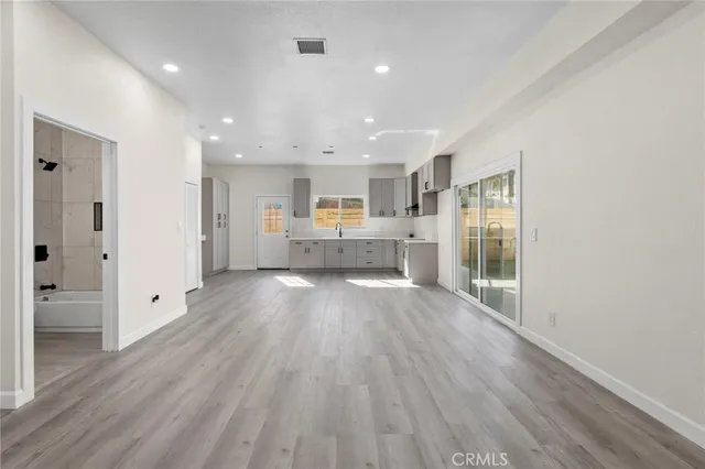 a view of kitchen with refrigerator sink and cabinets