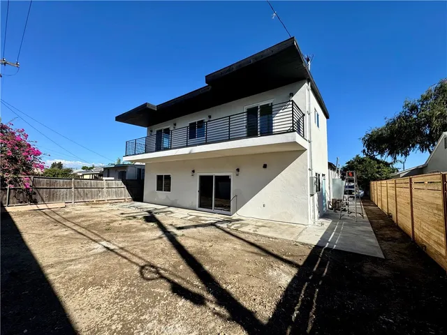a backyard of a house with table and chairs