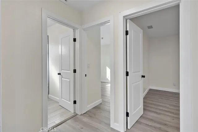 a view of a hallway with wooden floor