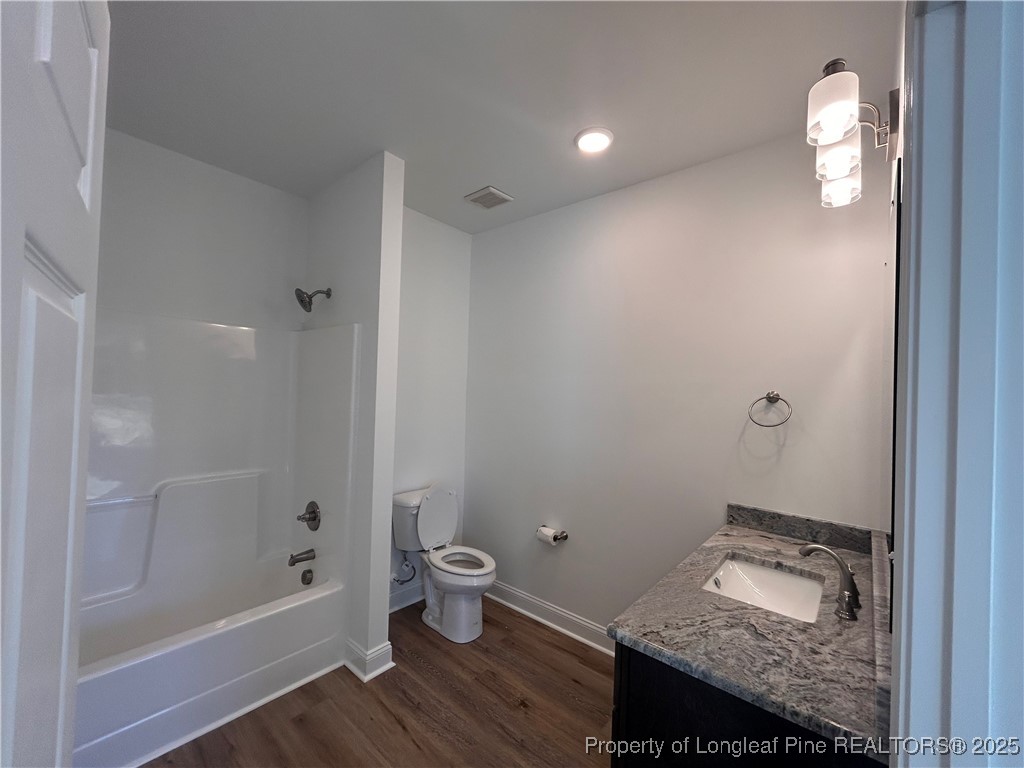 403 Morehead Street Spring Lake, NC 28390 - Photo 14 of 15 a bathroom with a granite countertop sink and a mirror