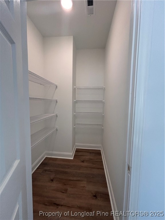 403 Morehead Street Spring Lake, NC 28390 - Photo 6 of 15 a view of walk in closet with empty racks