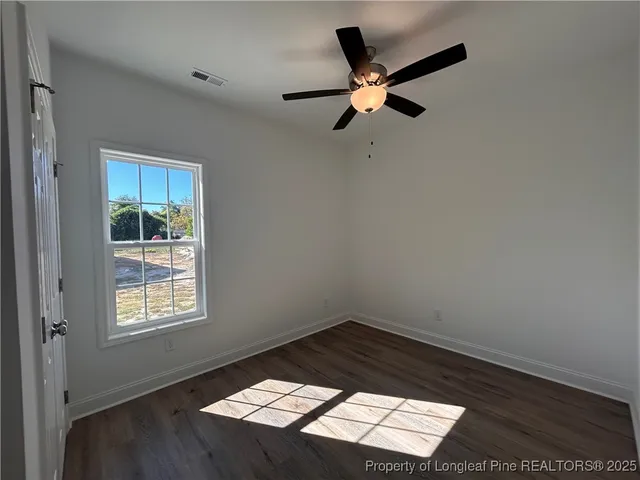 a view of a ceiling fan and wooden floor in a room
