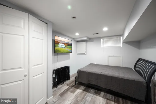 a bedroom with a bed and a television