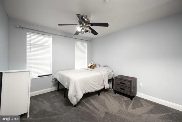 a spacious bedroom with a bed and a window