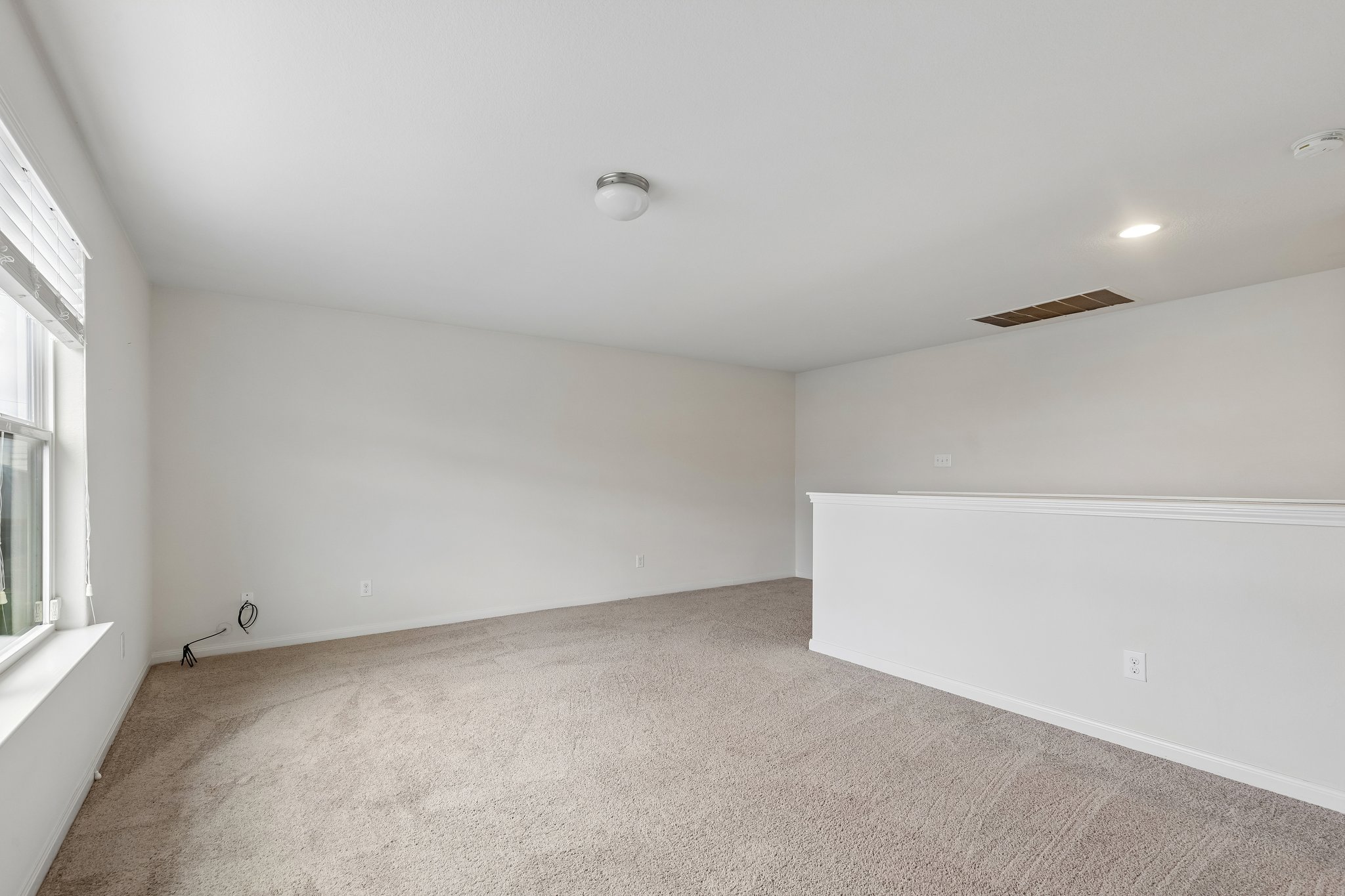 704 Cleary Lane Jarrell, TX 76537 - Photo 11 of 25 Spacious upper-level room featuring light-colored carpeting and white painted walls